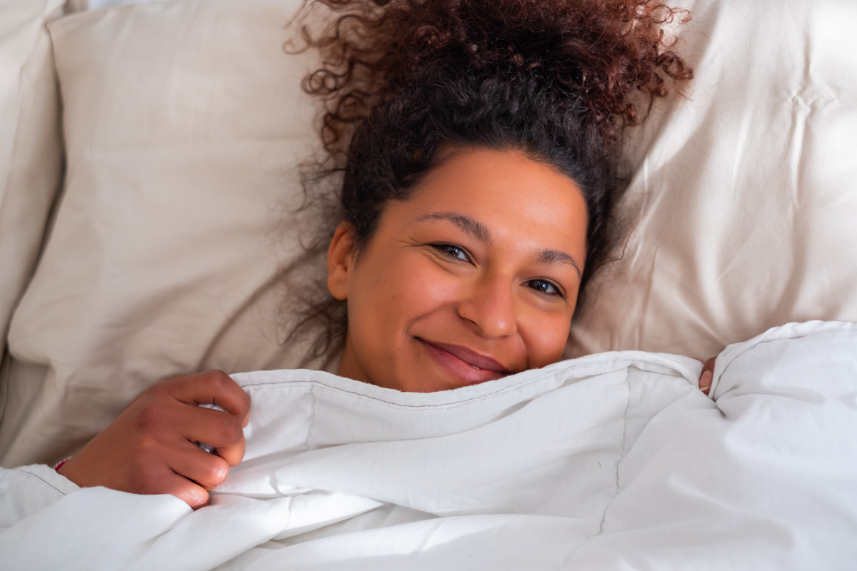 Rested and refreshed black woman in bed